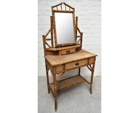 An early 20th century bamboo mirror back dressing table, with two drawers raised on column supports, height 152cm.Additional 