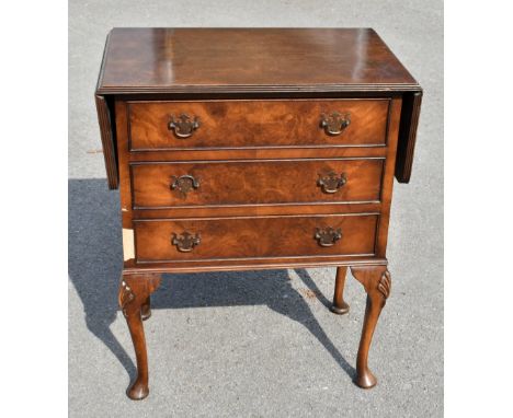 A reproduction walnut drop leaf chest, with three drawers on shell carved cabriole legs, height 73cm, width 60cm, depth 38cm.