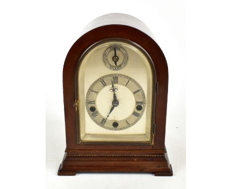 An early 20th century German mahogany cased dome topped mantle clock, the silvered face with applied chapter ring bearing Rom