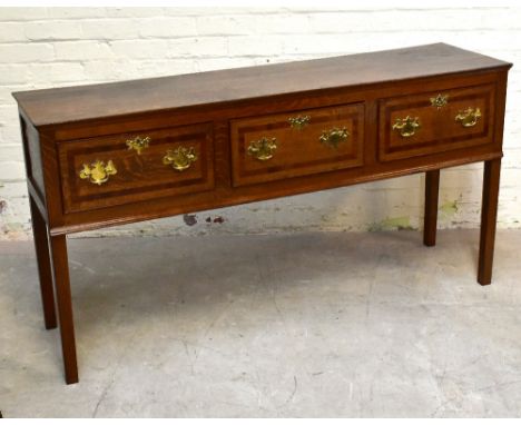 A late 18th century oak dresser, the rectangular top above three drawers with mahogany crossbanding, on tapered square legs, 