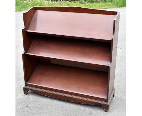 A reproduction mahogany three tier book trough, raised on shaped bracket feet, height 121cm, length 119cm, depth 42cm.