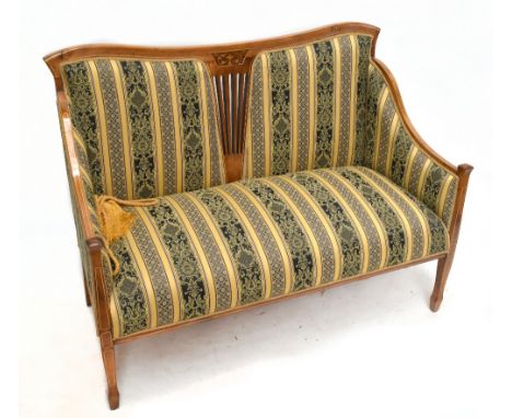 An Edwardian inlaid mahogany two seater sofa with pierced detail to the central back, upholstered in a striped and floral mat