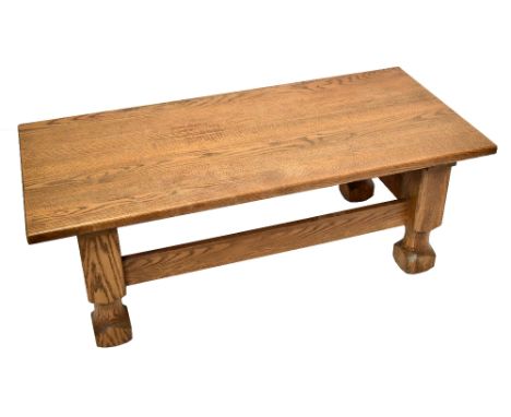 A modern light oak rectangular coffee table, on chunky square legs, height 47cm, width 130cm, depth 59cm.
