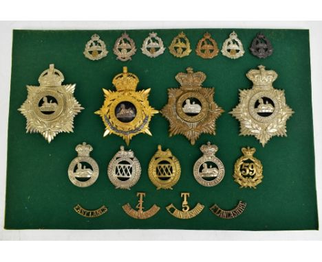 EAST LANCASHIRE REGIMENT; a good group of badges including four helmet/shako plates, one gilt with applied white metal ribbon