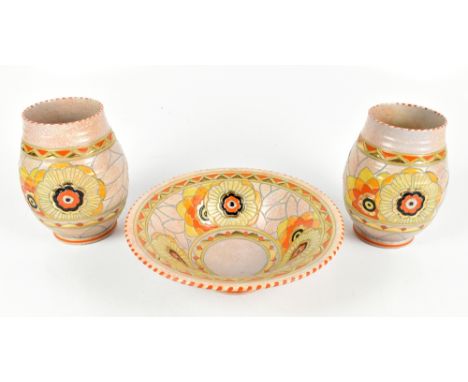 CHARLOTTE RHEAD FOR CROWN DUCAL; a floral tubeline decorated bowl and pair of ovoid vases with enamelled and gilt detail on s