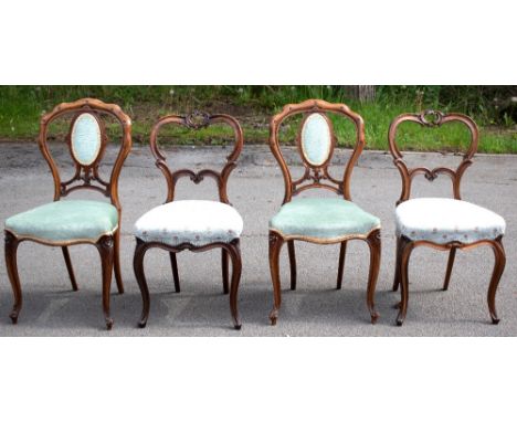 GILLOWS; a pair of Victorian carved rosewood side chairs, with scroll carved backs and floral upholstered seats, on cabriole 