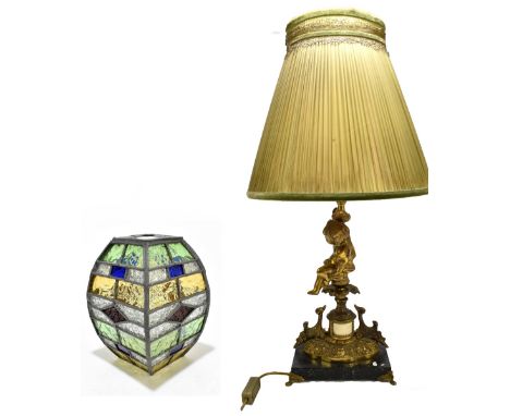 A reproduction gilt metal figural table lamp modelled as a seated child supported the single branch, raised on rectangular ma