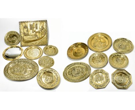 A collection of thirteen early 20th century embossed brass wall plates and chargers, probably Dutch, each&nbsp;decorated with