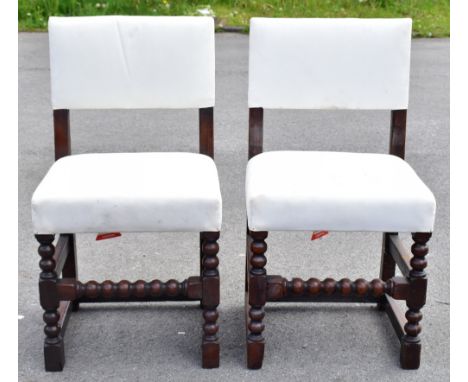 A harlequin set of six 19th century oak framed dining chairs, upholstered in a cream material, raised on bobbin turned column
