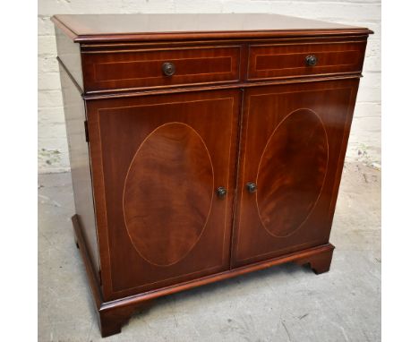 A reproduction inlaid mahogany side cabinet, the single frieze drawer above two panelled cupboard doors, raised on bracket fe