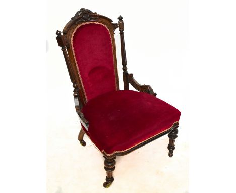 A Victorian carved rosewood lady's salon chair with burgundy dreylon upholstered back and seat on turned and fluted tapered l