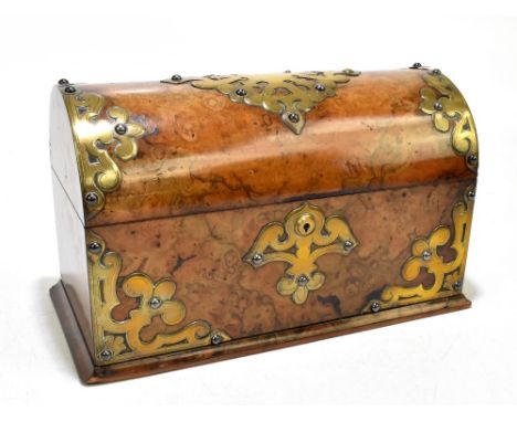 A Victorian brass mounted walnut domed top tea caddy, decorated with pierced foliate mounts with hinged lid enclosing an inte