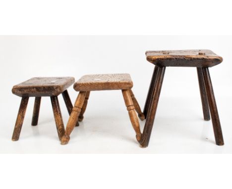 Three late 19th century rustic vernacular oak stools, the larger with a canted square top, height 32.5cm, another on turned l