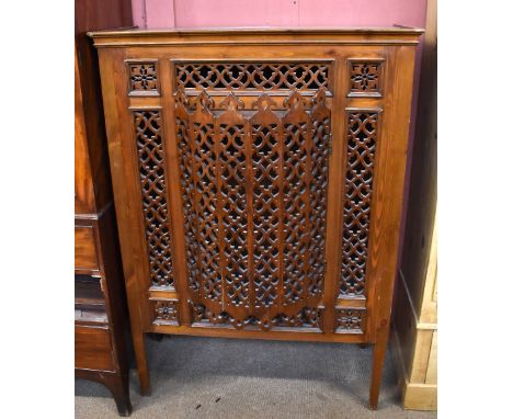 An Egyptian carved pine mashrabiya cabinet, with bow front door enclosing glass shelves, on square legs, 150 x 104 x 47.5cm.A