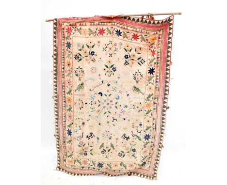 A South East Asian tapestry wall hanging with embroidered decoration of flora, fauna, script and Buddhist symbols and further