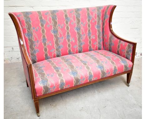 An Edwardian inlaid mahogany wing back salon settee, with floral red upholstery, on tapered legs, height 92cm, width 120cm, d