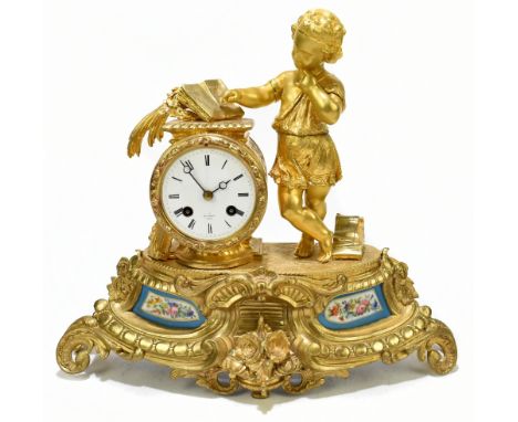 HENRY MARC; a French 19th century Ormolu figural mantel clock depicting a child reading beside the circular enamel dial with 