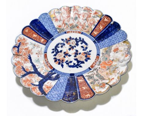 A large late 19th century Japanese Imari charger, of circular form with panelled detail depicting mythical birds, creatures a