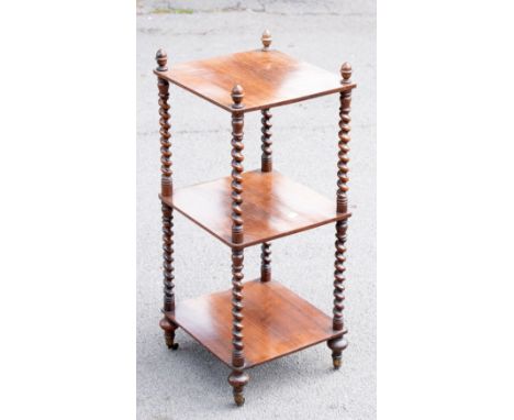 A 19th century rosewood three tier whatnot of small proportions, with acorn shaped finials and barleytwist uprights, on turne