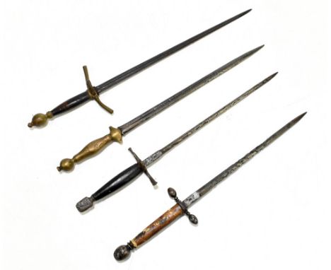 Four daggers including a parrying-type example, the brass hilted example stamped to blade 'In Toledo', the other blades appar