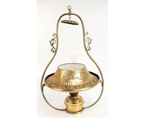 A hanging oil lamp with relief decorated frame and shade, clear glass chimney and brass reservoir, height approx 69.5cm.Addit