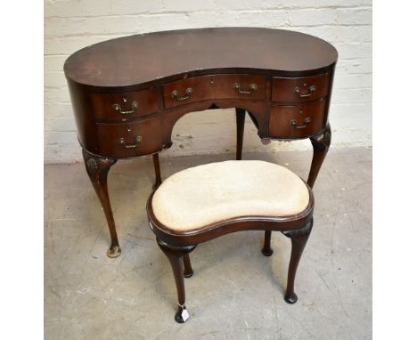 An early 20th century mahogany kidney shaped dressing table, with an arrangement of five drawers, raised on cabriole supports
