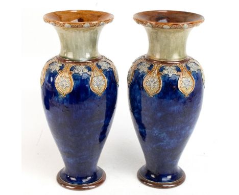 ROYAL DOULTON; a large pair of Art ware vases with flared necks with applied stylised floral detail, impressed mark to the un