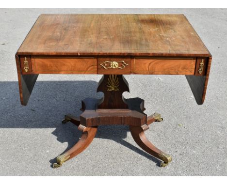 A Regency brass inlaid rosewood sofa table with two rounded rectangular side flaps and two frieze drawers above a shaped supp