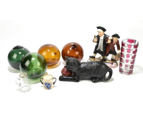 A late 19th century Staffordshire figure group of two toppers,&nbsp;height 21cm, with four glass fishing floats, a Bretby mod