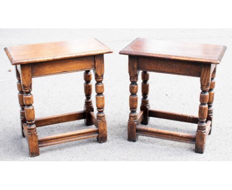 Two 17th century-style oak joint stools, each with a moulded rectangular top on turned legs and block feet, the taller height