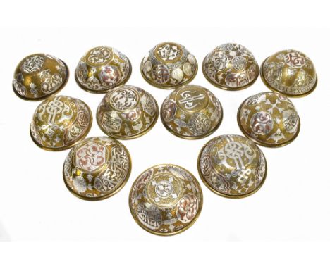 A set of twelve late 19th century Cairoware white metal and copper inlaid brass bowls, each profusely decorated with panels o