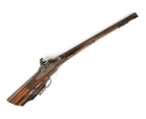 An unusual small bore flintlock musket with short carved stock with ivory butt plate and sliding compartments, fitted with 21