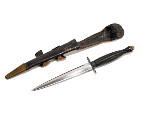 WILLIAM RODGERS OF SHEFFIELD; a Fairbairn-Sykes Commando dagger with typical ribbed grip, blade length 15.7cm, in brass mount