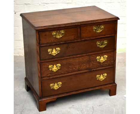 A George III style oak chest of small proportions with two short over four graduated long drawers, on bracket feet, height 73
