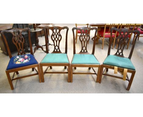 A set of four Georgian mahogany dining chairs in the Chippendale style, each with drop-in seats, raised on tapering block sup