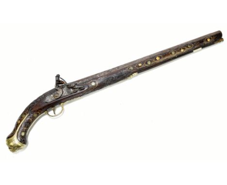A large 19th century flintlock pistol with 19" engraved barrel, mounted to a carved and floral inlaid stock and mounted with 