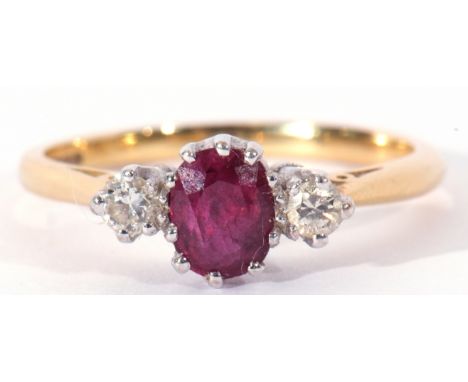 18ct gold ruby and diamond three stone ring, the oval faceted ruby 6 x 4mm, flanked by two small brilliant cut diamonds, 0.10