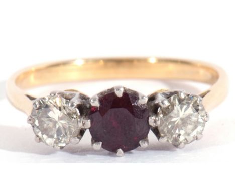 Ruby and diamond three-stone ring, the round faceted ruby flanked by two round brilliant cut diamonds, 0.20ct approx each, si