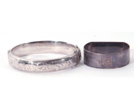 A hallmarked silver hinged bracelet, together with a silver D shaped napkin ring with engine turned decoration. 31.3gms