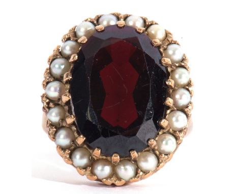 Modern 9ct gold dress ring, a large red paste faceted stone, 18 x 12mm, within a seed pearl surround, size P