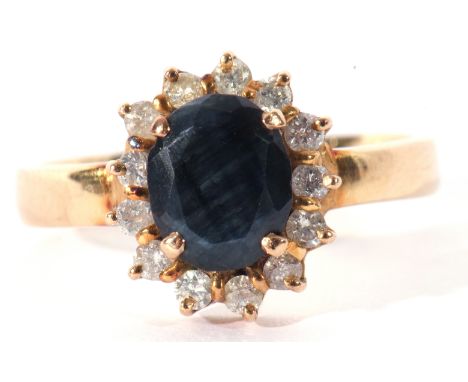 Sapphire and small diamond cluster ring, the oval shaped sapphire 8 x 6mm, raised above a small diamond surround, plain polis