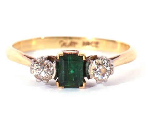 Emerald and diamond three stone ring, the step cut emerald 4.3mm x 3mm, flanked by two round brilliant cut diamonds, 0.20ct a