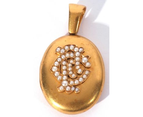 Victorian oval gold hinged locket, the front applied with a seed pearl decorated monogram, the verso engraved '8th May 1801 -