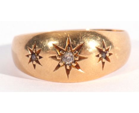 Early 20th century 18ct gold and three stone diamond ring featuring three graduated small diamonds, each in star engraved set