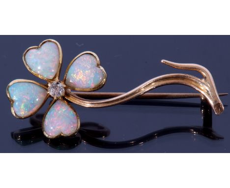 An opal and diamond brooch, a flower design with four heart shaped opal petals highlighted with a small brilliant cut diamond