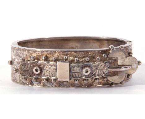 Antique silver hinged bangle, the top section chased and engraved and applied with a belt and buckle design, Birmingham 1893,