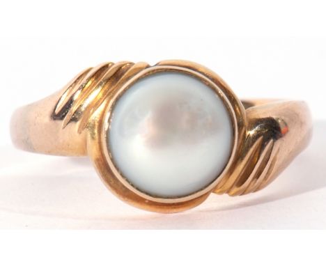 Yellow metal and cultured grey pearl ring, the pearl 8mm diam, bezel set between engraved cross over shoulders, size R, unmar