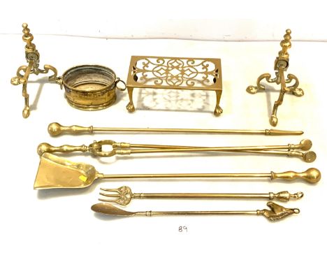 Assorted brassware inc. Fire irons, fire dogs, trivet stand, brass pot, toasting fork and horse head shoe horn