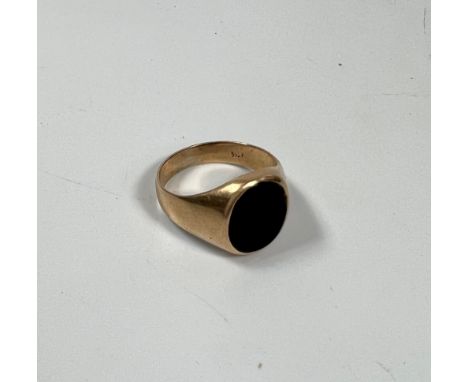 A 14k gold signet ring set with black stone size M. 