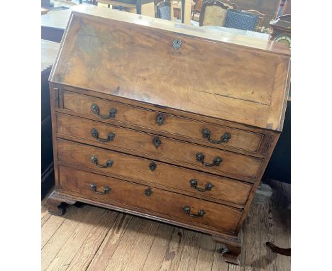 A George III Mahogany Bureau. Circa 1770. The fall front opening to reveal a fitted interior. Above four long graduated drawe